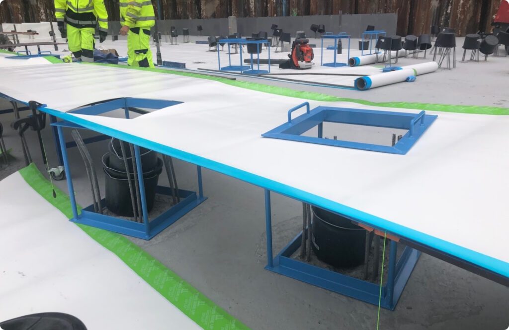 Preprufe sheet laid over blue steel frames around pile groups on the Danske Bank base slab