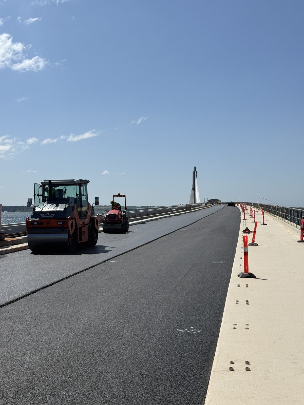 Asphalt being laid and rolled on top of bond coat and membrane on the Storstrøm Bridge carriageway, May 2025