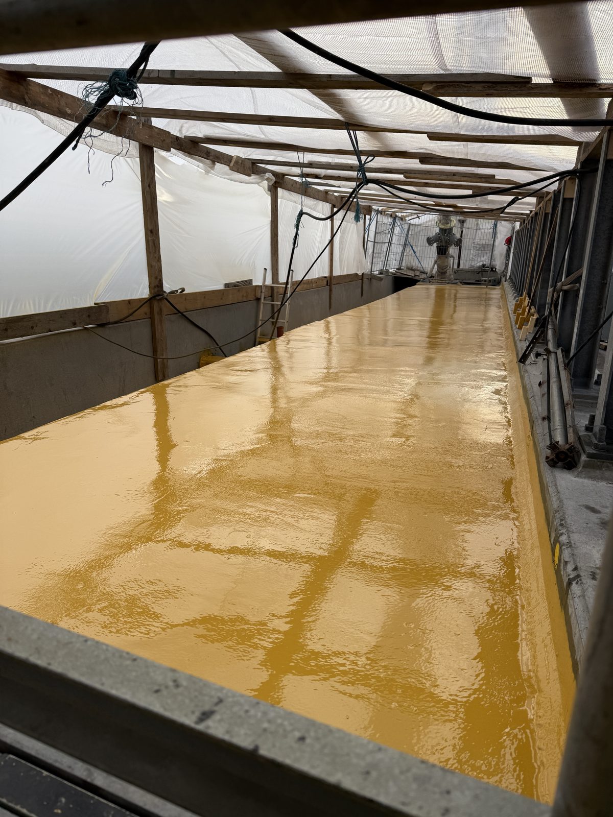 Emergency walkway on the Storstrøm Bridge with yellow Eliminator membrane under cover