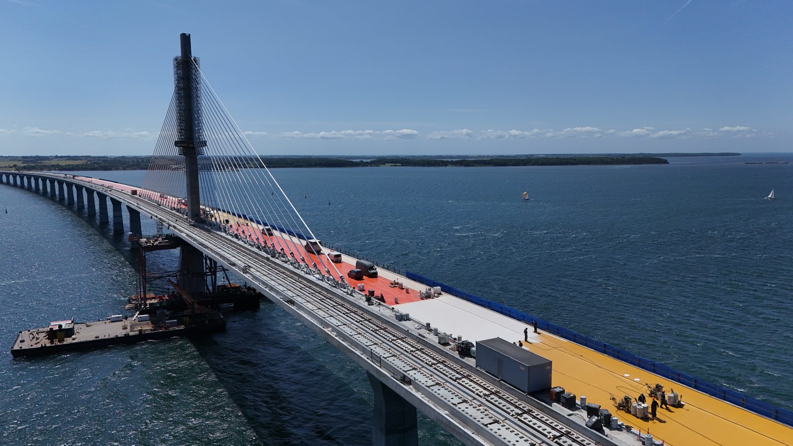 Drone shot of the Storstrøm Bridge pylon with yellow Type 5 membrane on the bridge deck, June 2025